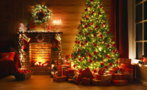 This is a picture of a Christmas tree and a fireplace. 